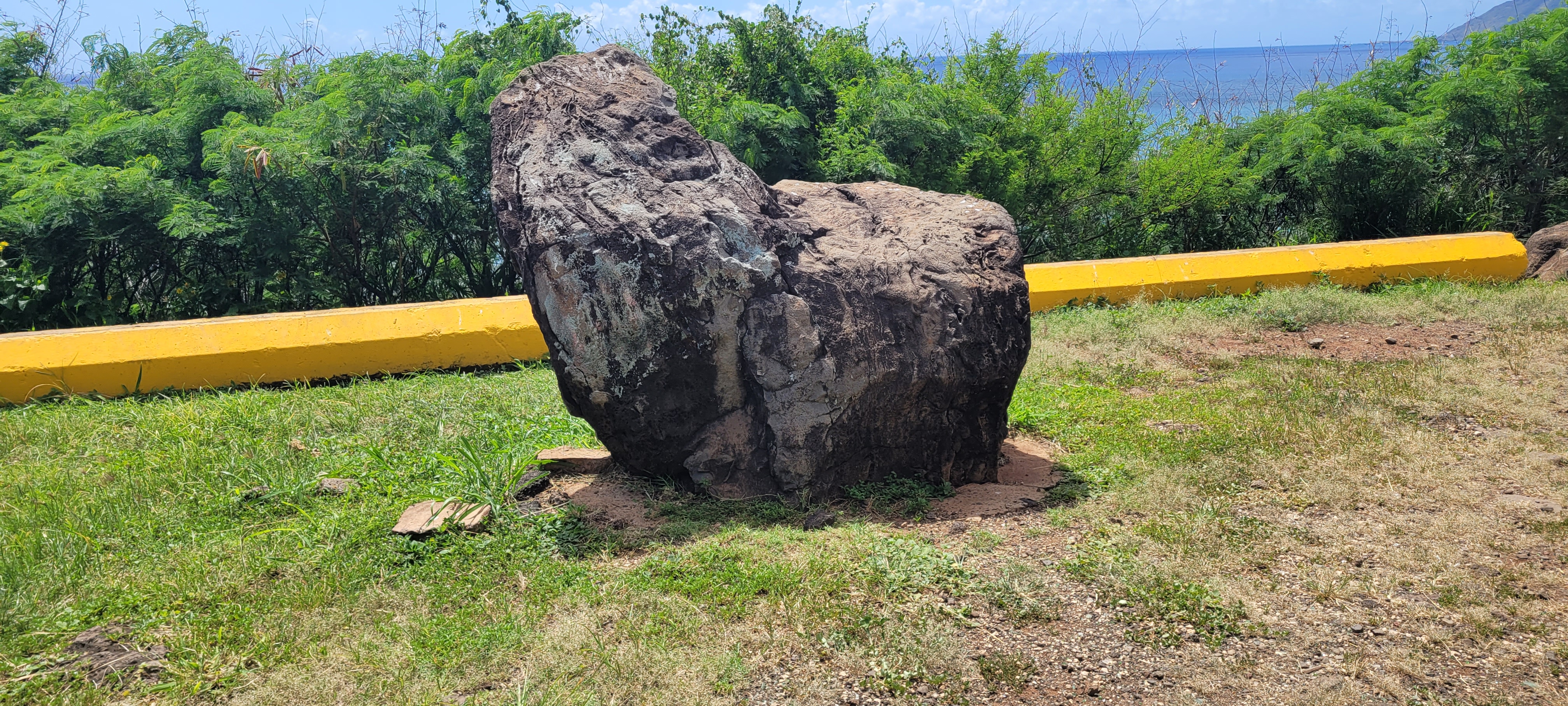 A large stone, with many markings from centuries of offerings.